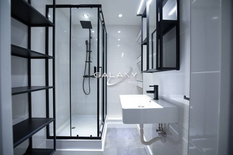 Modern bathroom with dark accessories and a shower in a 3-room apartment on Boriny Street.