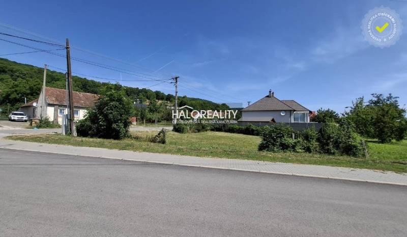 Plots - housing in Smolenice, road, houses and greenery in the background.