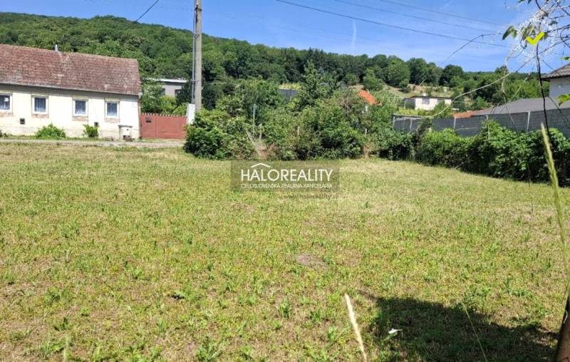 Plots - housing in Smolenice surrounded by greenery, with a country house nearby.