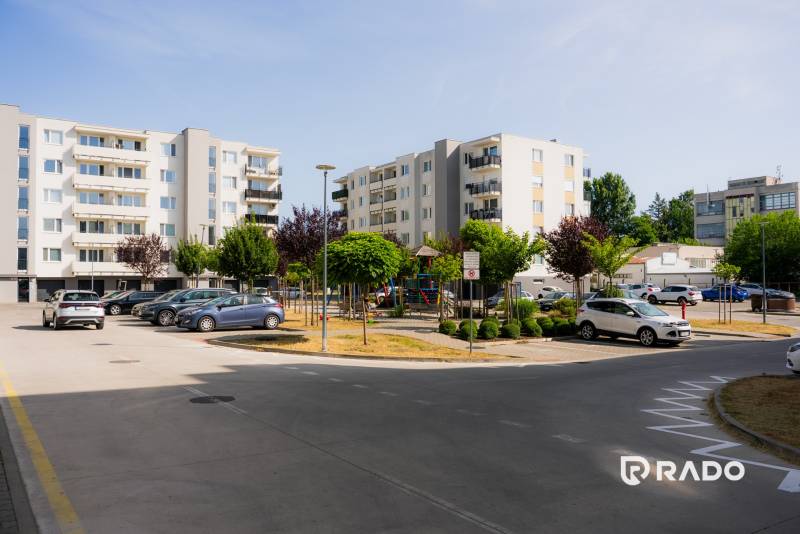 Five-story apartment buildings with parking and greenery in Trenčín near a 2-room apartment.