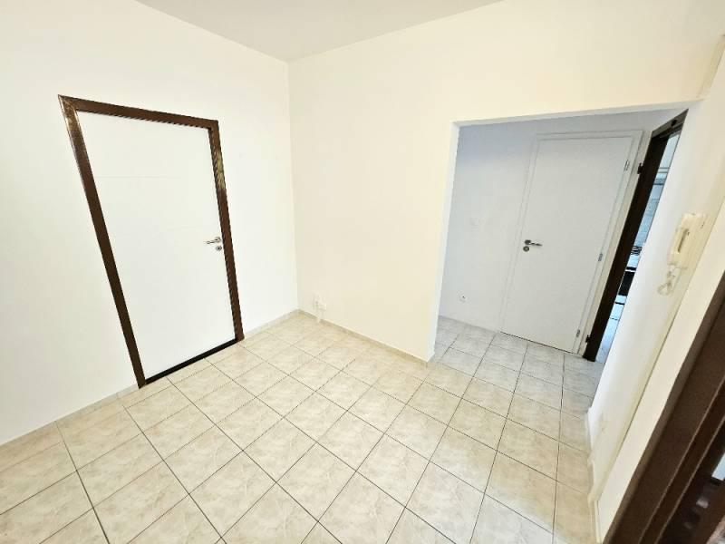 Interior of a 3-room apartment with white walls and tiles.