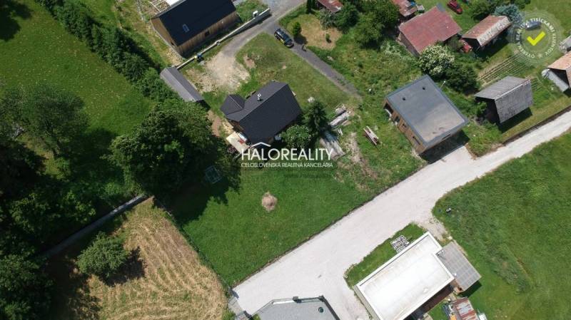 Aerial view of residential plots in Malatíny with buildings and greenery.