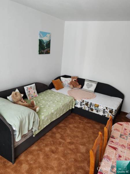 A room in a 3-room apartment with two sofas and wall decorations.