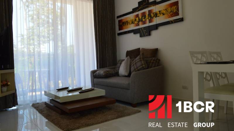 Living room in a two-room apartment with a comfortable sofa and a coffee table.