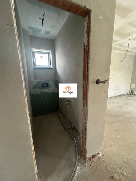 Unfinished bathroom in a family house with a window and installation.