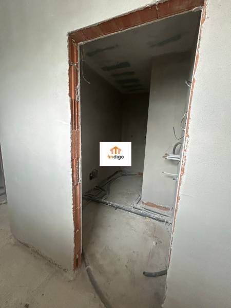 An unfinished room with nets and uncovered bricks in a family house.