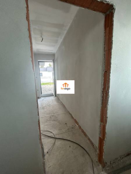 A hallway without finished walls and electrical wiring in a family house.