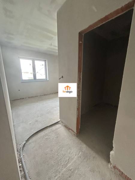 The interior of a family house with unfinished walls and an open window.