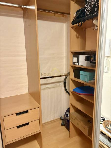 Wooden wardrobe with shelves and a hanger, drawers for accessories, storage space in a 2-room apartment.