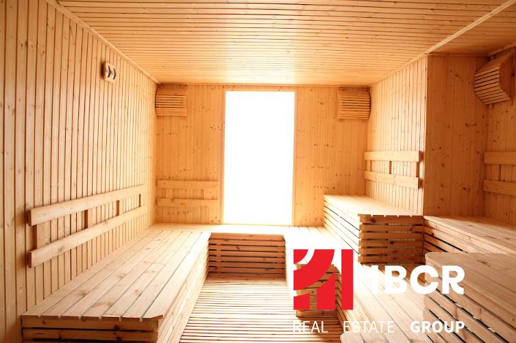 Wooden sauna with benches, natural light; Apartment construction.
