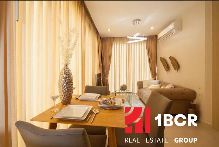 Dining room in a 2-room apartment with wooden furniture and hanging curtains.