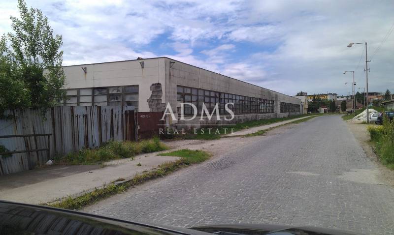 Warehouses and halls in Levice with neglected surroundings on a side street.