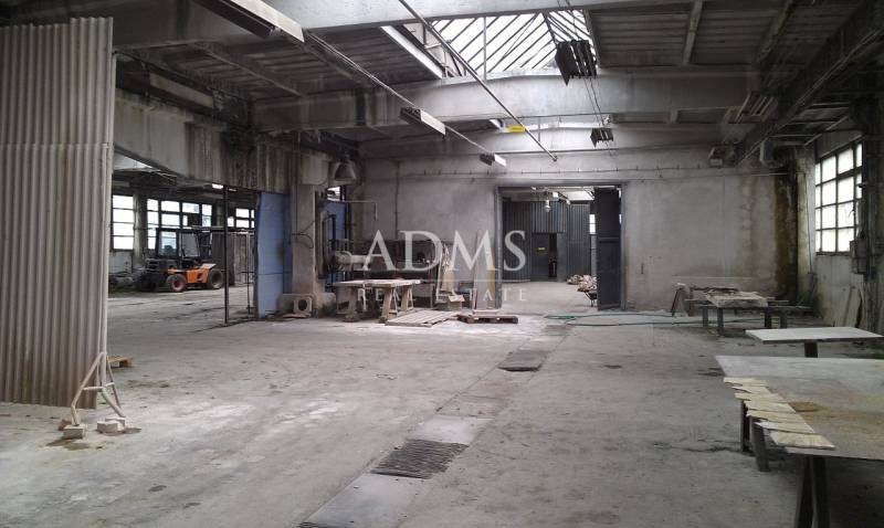 Industrial interior of warehouses and halls with workbenches and a forklift.