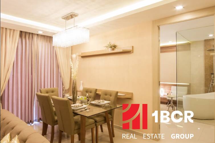 Dining area in a 3-room apartment with elegant lighting and a set table.