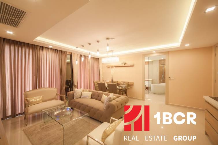 Luxury interior of a 3-room apartment with a comfortable sofa and a dining table.