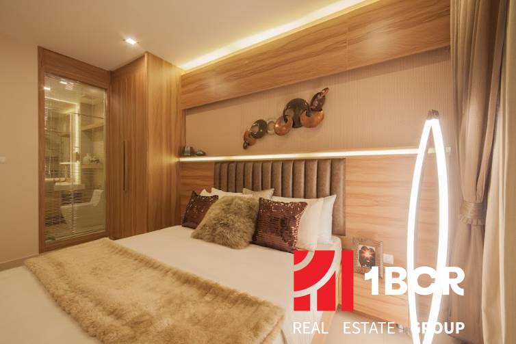 A bedroom in a 3-room apartment with a mirror, wooden elements, and soft lighting.