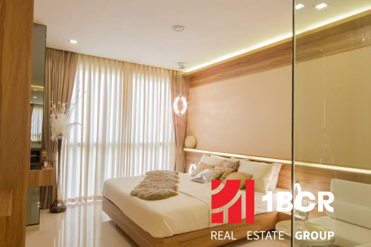 Stylish bedroom in a 3-room apartment with sheer curtains and wooden elements.