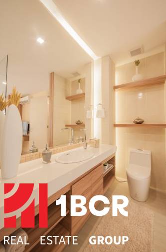 A bathroom in a 3-room apartment with a sink, toilet, and decorative shelves.