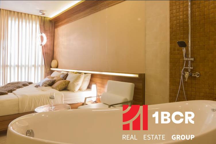 Luxury bedroom with a whirlpool in a 3-room apartment, harmonious combination of wood and natural shades.
