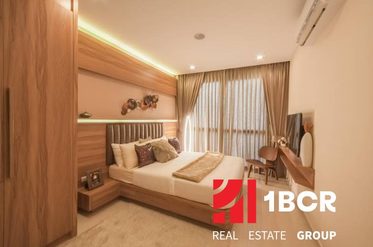 Interior of a 3-room apartment with an elegant bedroom, wooden furniture, and a large window with impressive curtains.