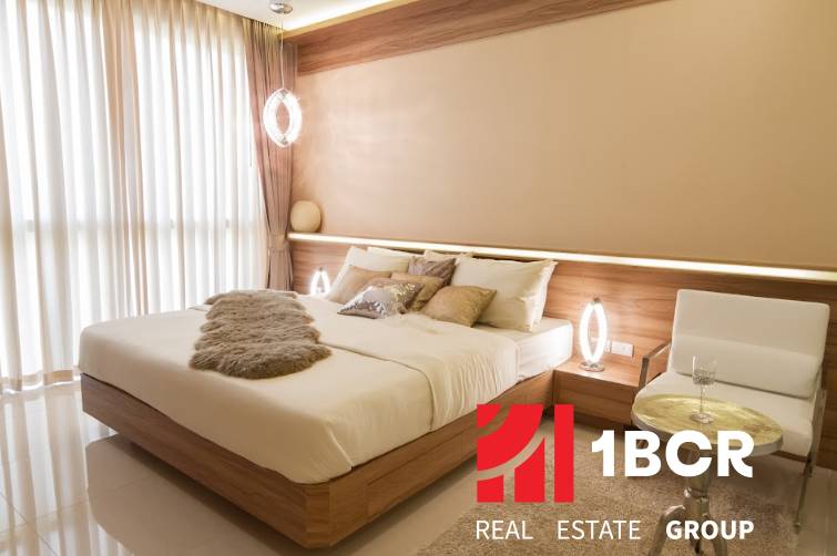 Bright bedroom with a comfortable bed in a 3-room apartment, modern furniture in neutral colors.