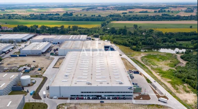 Logistics warehouses and halls in Bratislava - Devín surrounded by greenery and roads.