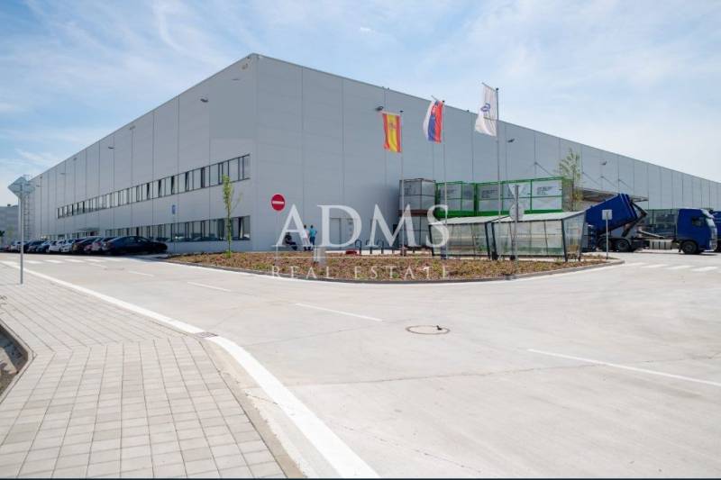 Exterior of warehouses and halls in Bratislava - Devín with parking and a cargo truck.