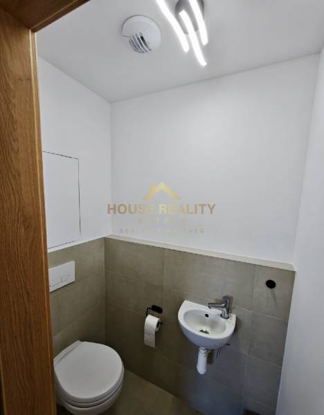 Bathroom in a 3-room apartment with a toilet and a small sink.