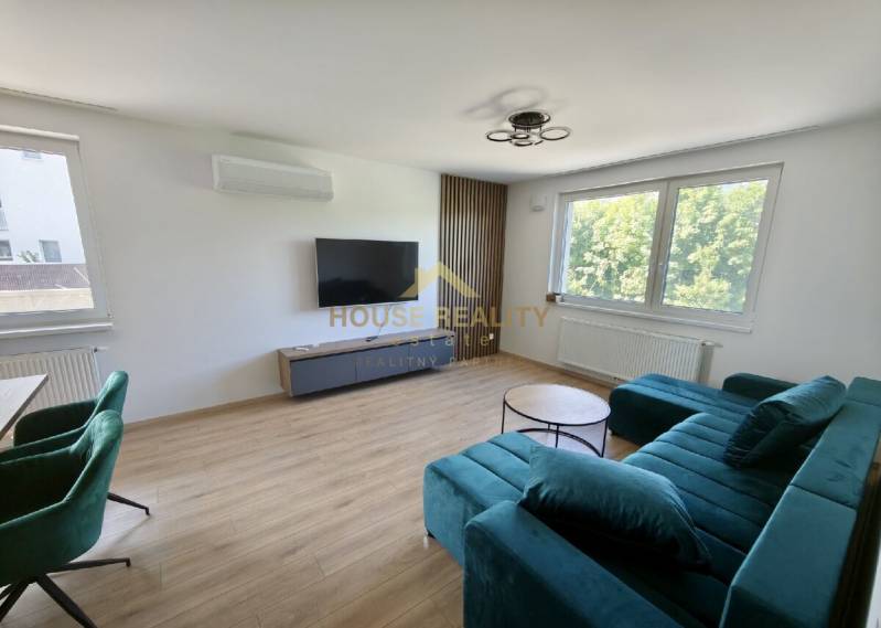Living room with a television, sofa set, and table in a 3-room apartment.