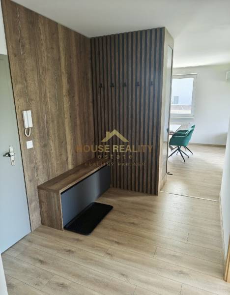 A hallway in a 3-room apartment with wooden paneling and a built-in wardrobe.