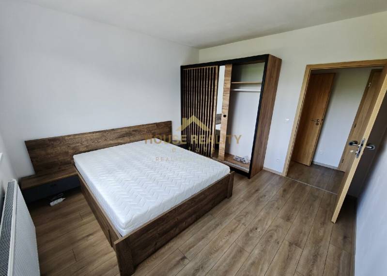 A bedroom in a 3-room apartment with light furniture and a double bed.