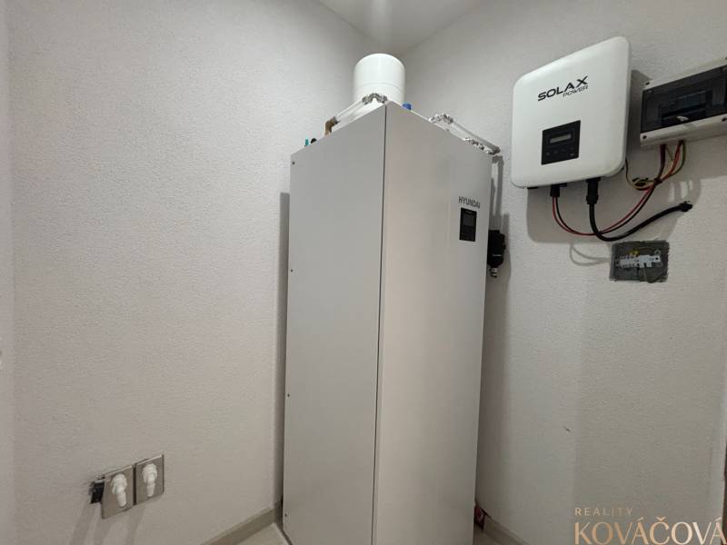 Equipment in the technical room of a family house with a Hyundai heat pump and a Solax unit.