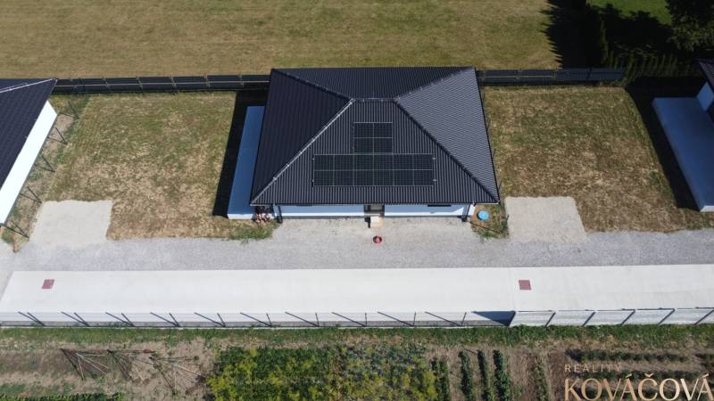 A family house in Podlužany with solar panels and a spacious garden.
