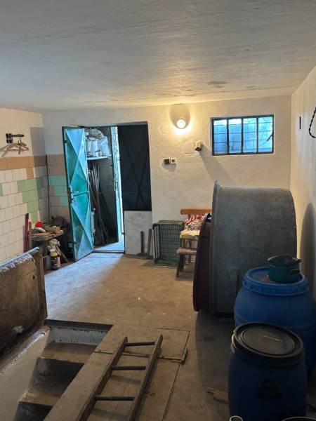In the room, there are barrels, a ladder, a door, tiles, and a light. Potential for recreational land.