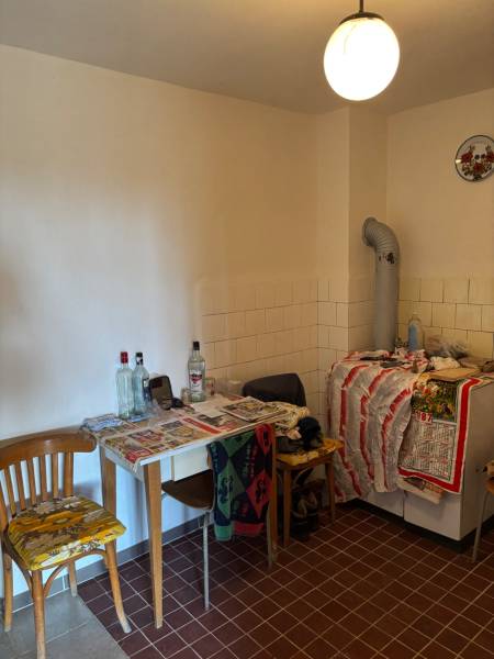 Old kitchen, tables and chairs with bottles, tiles, light, suitable for recreational properties.