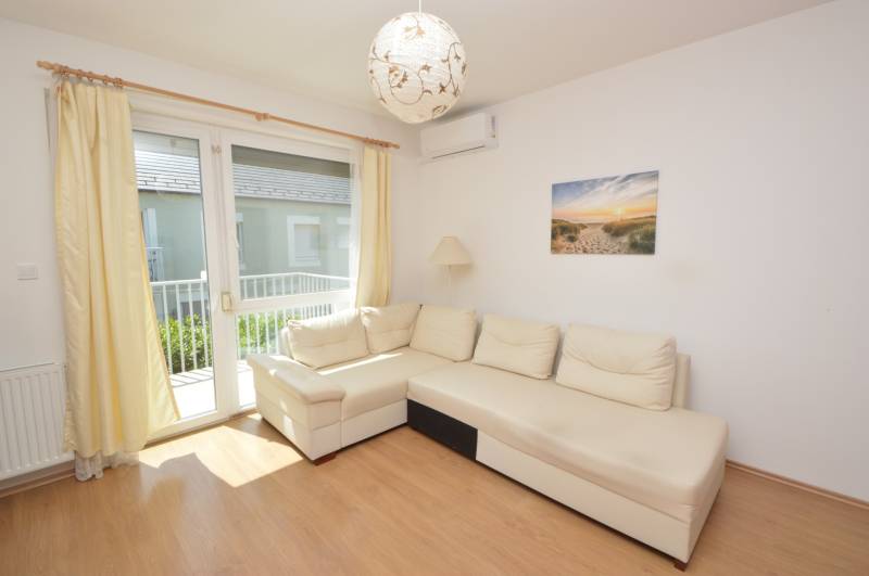 Bright living room with a white sofa in a 2-room apartment.