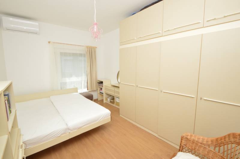 Bedroom in a 2-room apartment with a bed, wardrobe, and air conditioning.