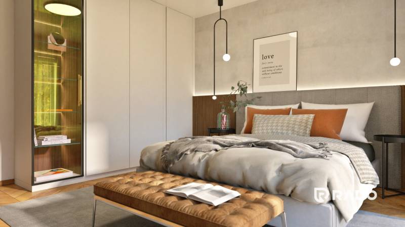 A bedroom in a two-room apartment with a bed, a cabinet, and decorative pillows.