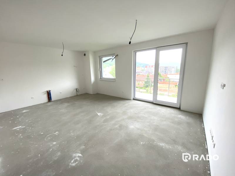 Unfurnished room in a 2-bedroom apartment with a large window and view.