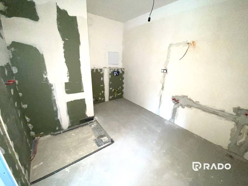 The interior of an unfinished 2-room apartment with prepared wiring on the walls.