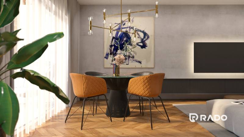 Dining area with orange chairs and decoration in a 2-room apartment.