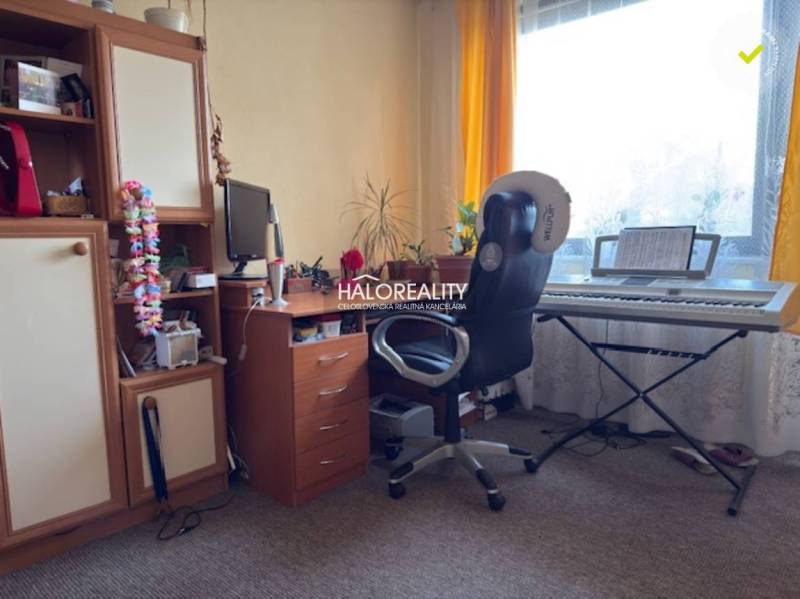 Room in a family house with keyboards, a desk, and a wardrobe.