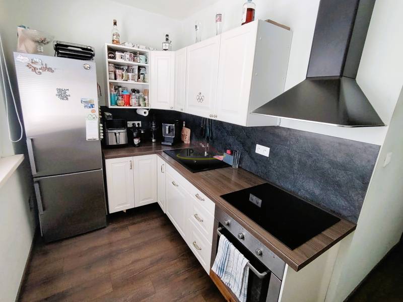 A kitchen in a 2-room apartment, equipped with appliances and storage space.