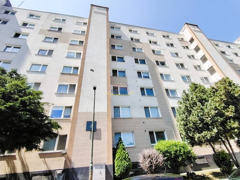 Apartment building on Hornádska Street in Bratislava with trees and parking.