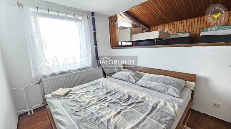 A bedroom in a family house with a single bed and an attic section with an additional bed.