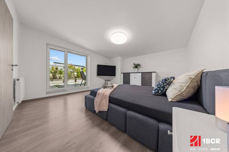 Bedroom in a 4-room apartment with a double bed and terrace doors.