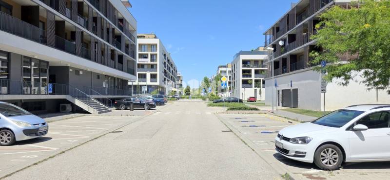 Žltá Street in Bratislava - Petržalka with modern apartment buildings and a parking lot.
