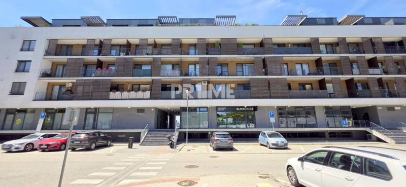 Apartment building on Žltá Street in the Bratislava - Petržalka area with parking in front of the building.