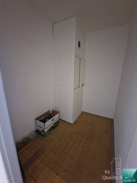 A small room with boxes and white walls in a 4-room apartment.