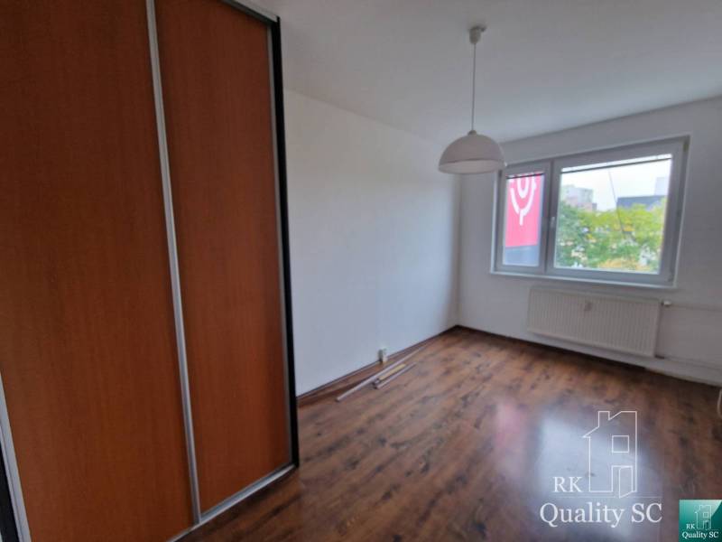 A room in a 4-room apartment with a wooden floor and a built-in wardrobe.